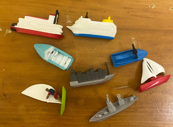 8 miniature water vessels on a wood background